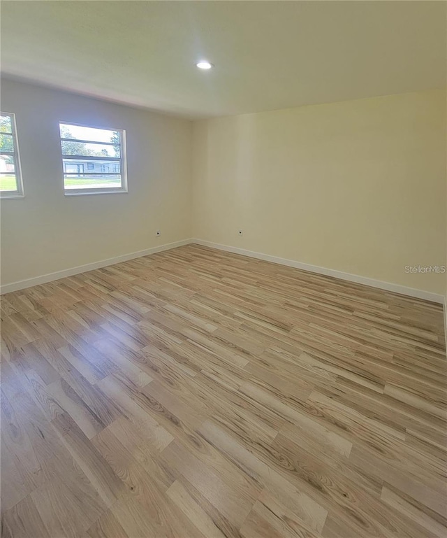1107 Greenwood Way, Cocoa, FL 32922 - empty room featuring light wood finished floors, plenty of natural light, baseboards, and recessed lighting