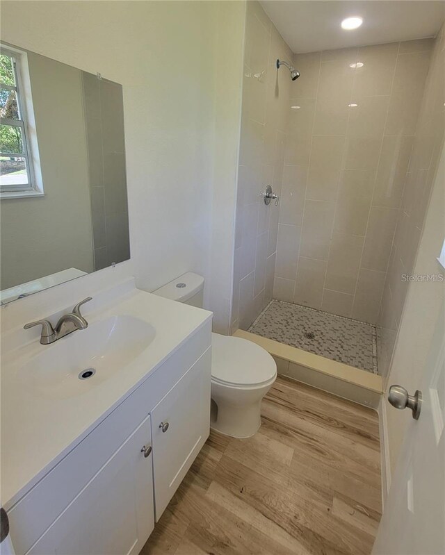 1107 Greenwood Way, Cocoa, FL 32922 - bathroom featuring wood finished floors, vanity, toilet, and a tile shower