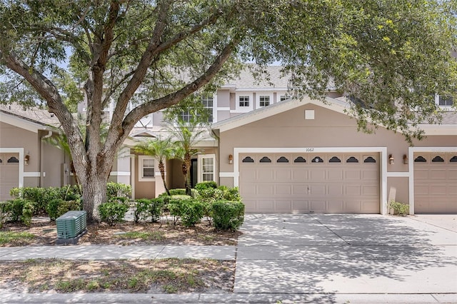 1062 Wickerwood St, Ocoee, FL 34761 - view of front of house featuring stucco siding, driveway, and an attached garage