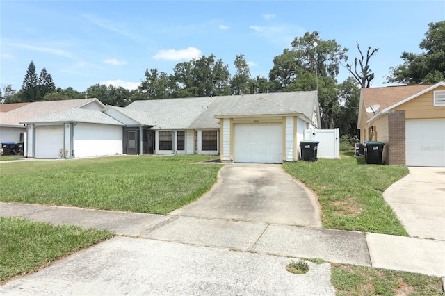 3939 Magnolia Lake Ln, Orlando, FL 32810 - ranch-style home featuring concrete driveway, a front lawn, and an attached garage