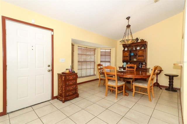 3939 Magnolia Lake Ln, Orlando, FL 32810 - dining space featuring lofted ceiling, light tile patterned flooring, and baseboards