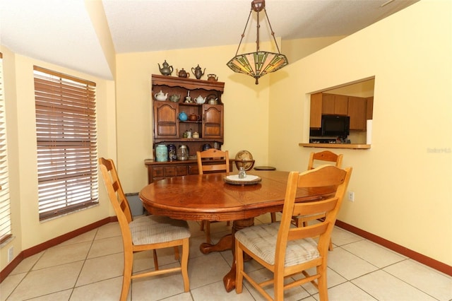 3939 Magnolia Lake Ln, Orlando, FL 32810 - dining room featuring vaulted ceiling, baseboards, and light tile patterned floors