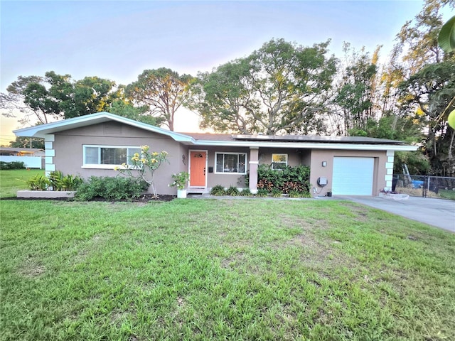 663 68th Ave S, Saint Petersburg, FL 33705 - single story home featuring stucco siding, a garage, solar panels, and concrete driveway