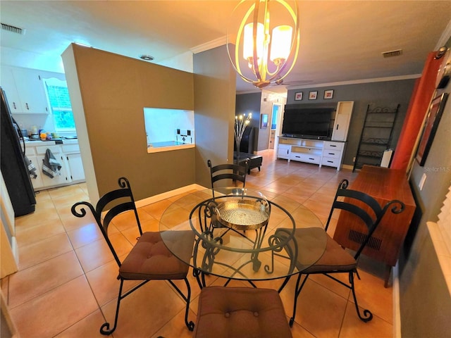 663 68th Ave S, Saint Petersburg, FL 33705 - dining room with crown molding, a chandelier, light tile patterned flooring, and baseboards