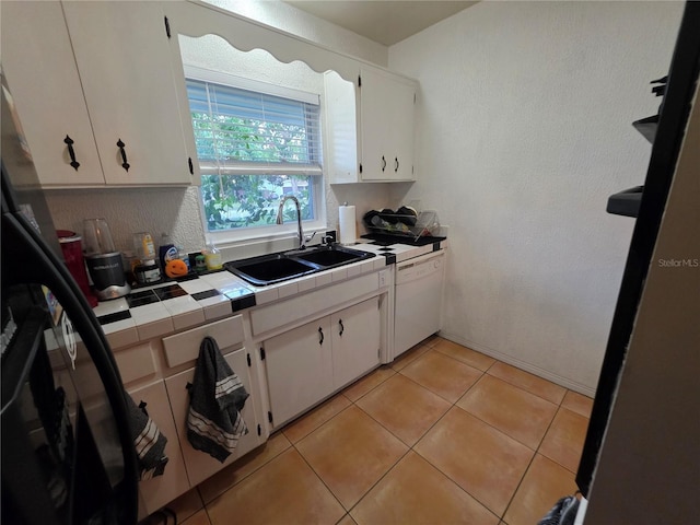 663 68th Ave S, Saint Petersburg, FL 33705 - kitchen featuring a sink, white dishwasher, tile counters, white cabinets, and light tile patterned flooring