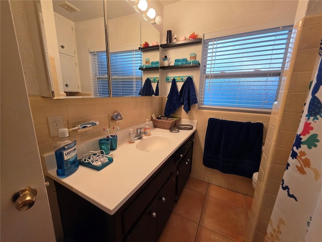 663 68th Ave S, Saint Petersburg, FL 33705 - full bath with vanity, tile patterned flooring, tile walls, tasteful backsplash, and toilet