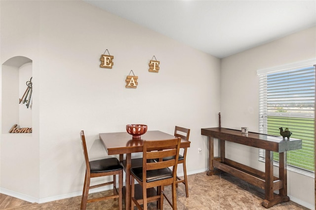 1805 Kingsmill Dr, Bartow, FL 33830 - dining space featuring arched walkways, healthy amount of natural light, and baseboards