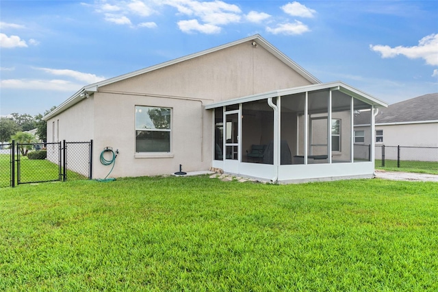 1805 Kingsmill Dr, Bartow, FL 33830 - rear view of property with a gate, a sunroom, and stucco siding
