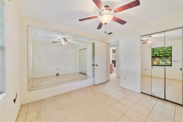 7024 Harwick Dr, Orlando, FL 32818 - unfurnished bedroom with a ceiling fan and light tile patterned flooring