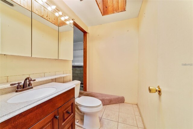 7024 Harwick Dr, Orlando, FL 32818 - bathroom featuring toilet, vanity, and tile patterned flooring