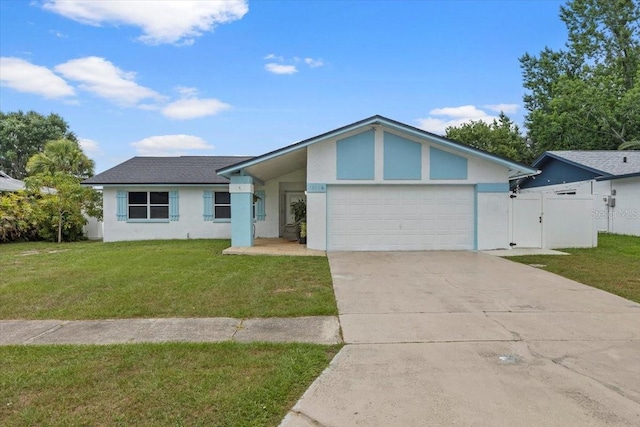 14506 Sutter Pl, Tampa, FL 33625 - view of front of house featuring a garage, stucco siding, driveway, and a gate