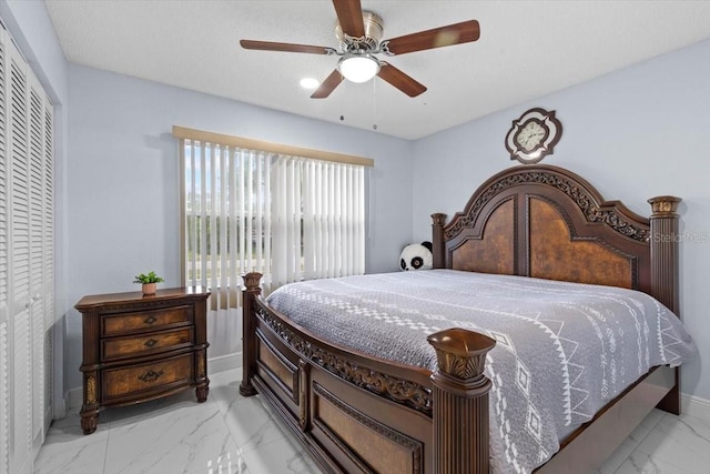 14506 Sutter Pl, Tampa, FL 33625 - bedroom with light marble finish floors, baseboards, ceiling fan, and a closet