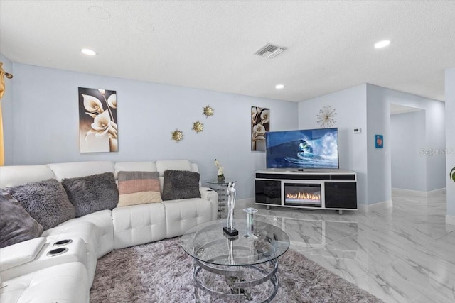 14506 Sutter Pl, Tampa, FL 33625 - living area featuring marble tiled flooring, a textured ceiling, recessed lighting, and a glass covered fireplace