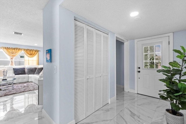 14506 Sutter Pl, Tampa, FL 33625 - entrance foyer with a textured ceiling, marble finish floors, baseboards, and plenty of natural light
