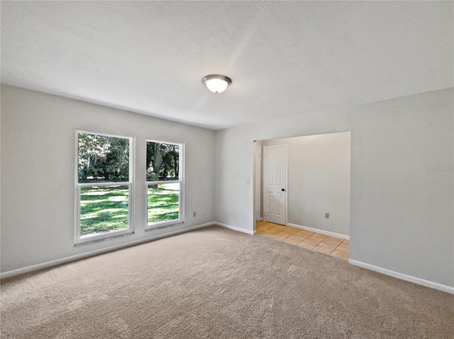 13794 SW 112th St, Dunnellon, FL 34432 - spare room with light carpet, baseboards, and light tile patterned flooring