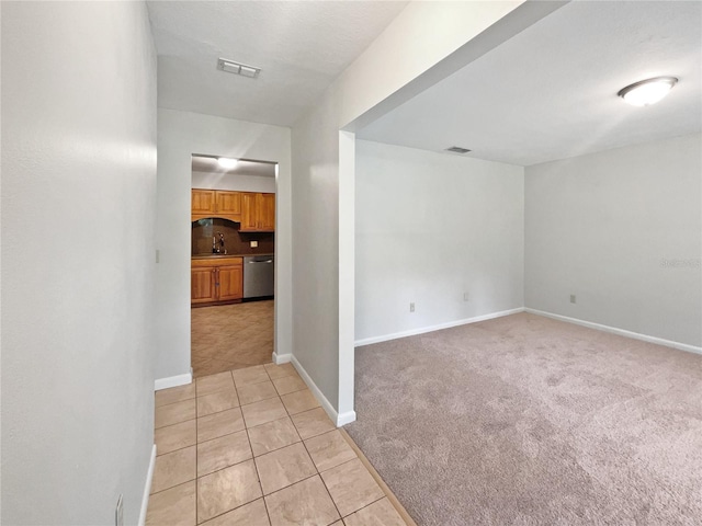13794 SW 112th St, Dunnellon, FL 34432 - unfurnished room with a sink, light tile patterned flooring, light colored carpet, and baseboards