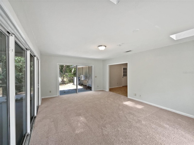 13794 SW 112th St, Dunnellon, FL 34432 - empty room with light colored carpet, baseboards, and a skylight