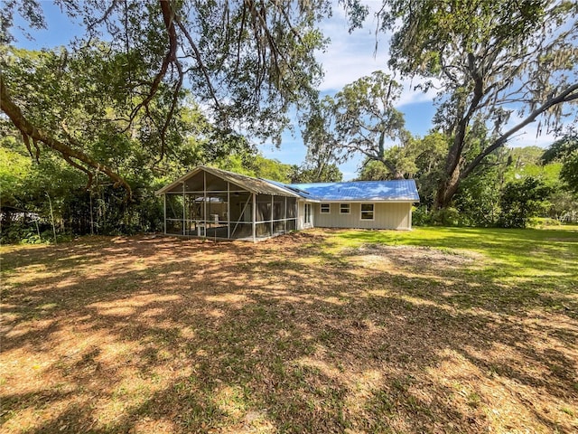 13794 SW 112th St, Dunnellon, FL 34432 - view of grassy yard with a sunroom