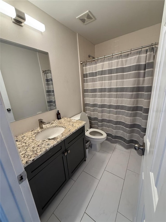 bathroom with vanity and marble look tile flooring