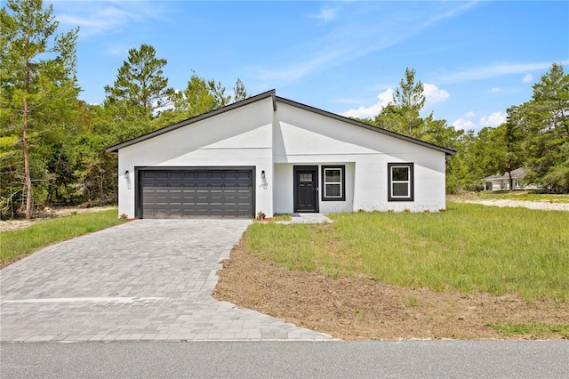 17762 SW 33rd Ter, Ocala, FL 34473 - view of front of property featuring a garage, decorative driveway, stucco siding, and a front lawn