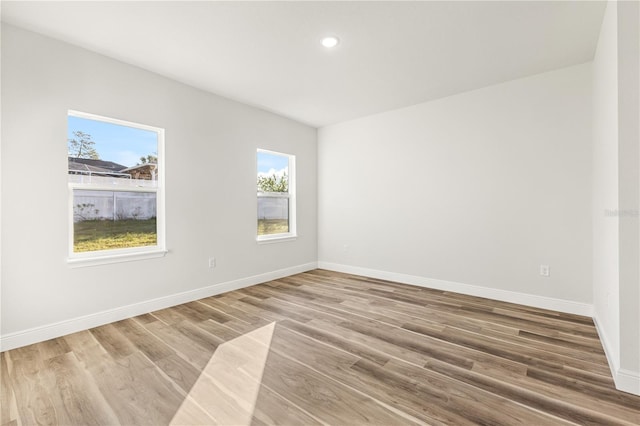 17762 SW 33rd Ter, Ocala, FL 34473 - empty room with plenty of natural light, wood finished floors, baseboards, and recessed lighting