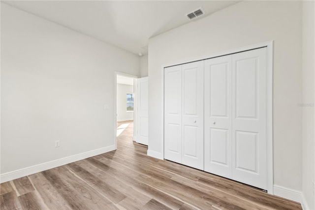 17762 SW 33rd Ter, Ocala, FL 34473 - unfurnished bedroom with light wood-style flooring, a closet, and baseboards