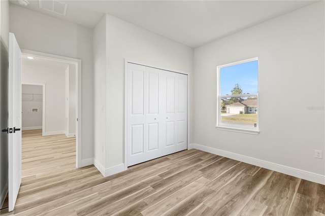 17762 SW 33rd Ter, Ocala, FL 34473 - unfurnished bedroom featuring light wood-type flooring, baseboards, and a closet