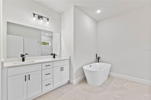 17762 SW 33rd Ter, Ocala, FL 34473 - full bath with marble look tiles, double vanity, baseboards, a soaking tub, and recessed lighting