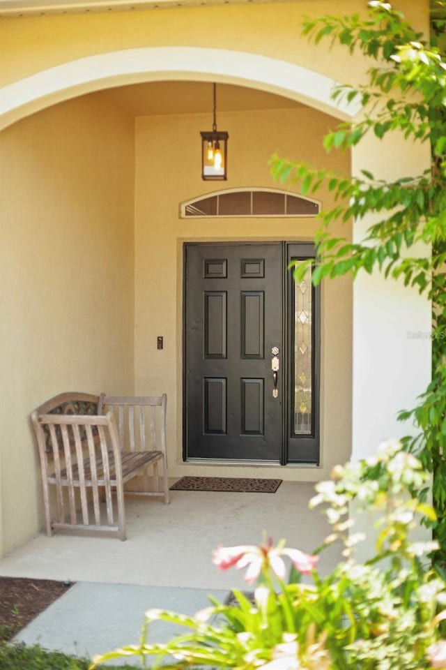 13631 Via Roma Cir, Clermont, FL 34711 - property entrance featuring stucco siding and a porch