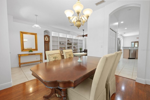 13631 Via Roma Cir, Clermont, FL 34711 - dining area with arched walkways, a chandelier, ceiling fan, wood finished floors, and recessed lighting
