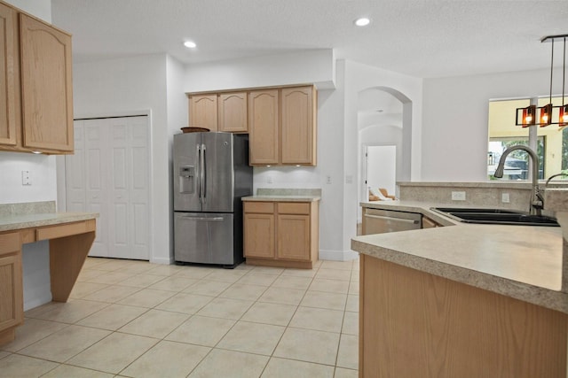 13631 Via Roma Cir, Clermont, FL 34711 - kitchen featuring appliances with stainless steel finishes, light brown cabinets, light countertops, light tile patterned floors, and decorative light fixtures