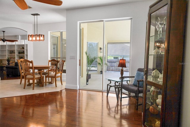 13631 Via Roma Cir, Clermont, FL 34711 - dining room featuring a ceiling fan, wood-type flooring, and arched walkways