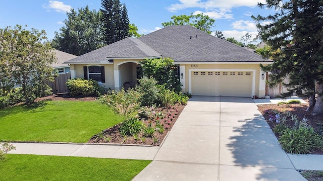 13631 Via Roma Cir, Clermont, FL 34711 - view of front of home with stucco siding, driveway, a shingled roof, and an attached garage