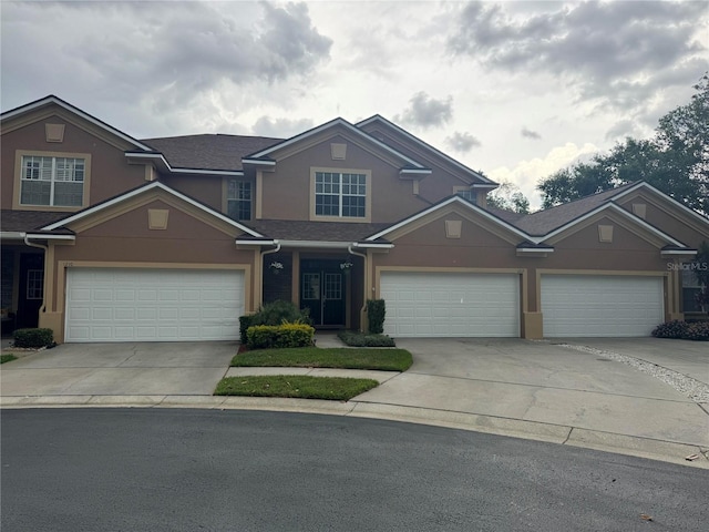 1212 Georgia Trace Ave, Valrico, FL 33596 - view of front of home with concrete driveway, stucco siding, an attached garage, and roof with shingles