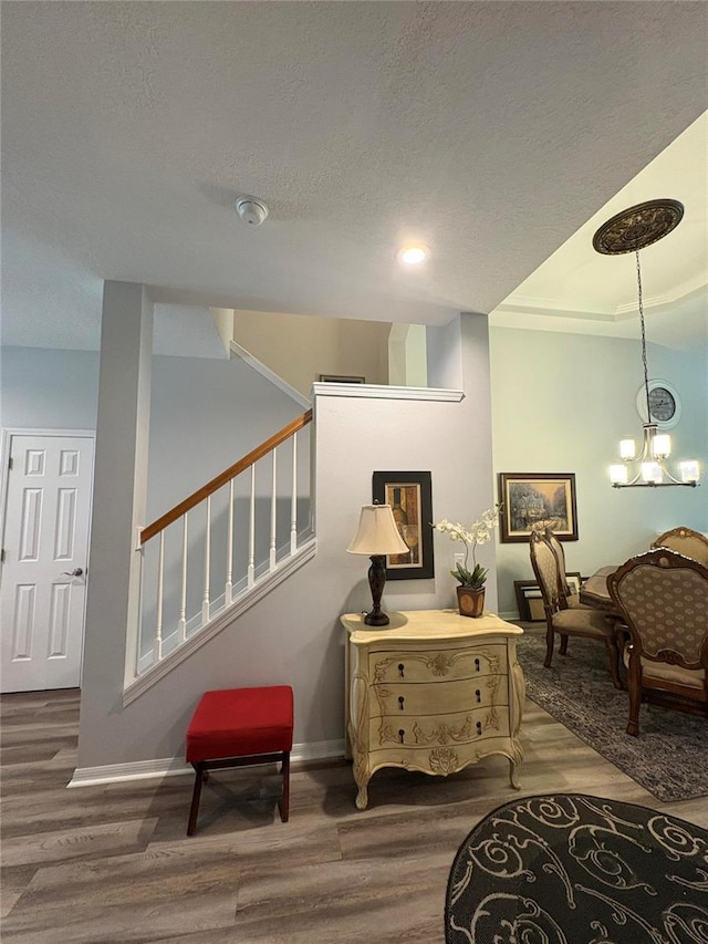1212 Georgia Trace Ave, Valrico, FL 33596 - sitting room featuring wood finished floors, a textured ceiling, stairway, baseboards, and a chandelier