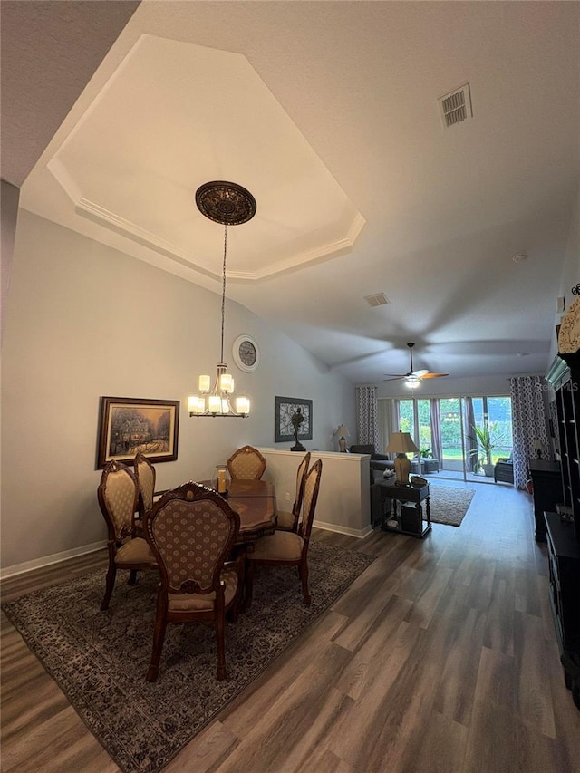 1212 Georgia Trace Ave, Valrico, FL 33596 - dining room with a tray ceiling, dark wood finished floors, baseboards, and a chandelier