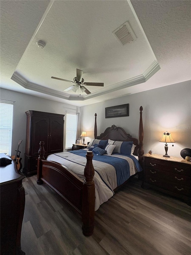 1212 Georgia Trace Ave, Valrico, FL 33596 - bedroom with a tray ceiling, a textured ceiling, wood finished floors, and ceiling fan