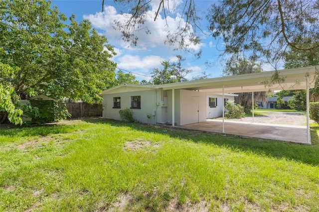 212 Homewood Dr, Sanford, FL 32773 - rear view of house featuring a carport and driveway