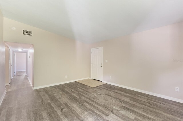 212 Homewood Dr, Sanford, FL 32773 - unfurnished room with wood finished floors and vaulted ceiling