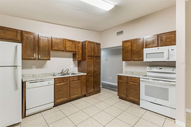 212 Homewood Dr, Sanford, FL 32773 - kitchen with white appliances, light countertops, and light tile patterned flooring