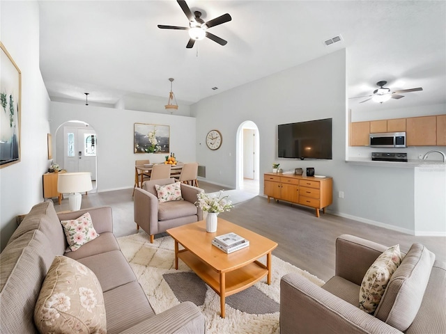 612 Doe Cove Pl, Apopka, FL 32703 - living room featuring arched walkways, a ceiling fan, and baseboards