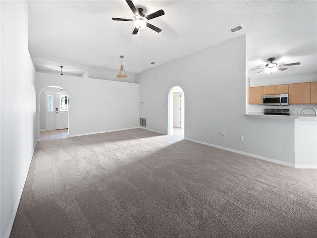 612 Doe Cove Pl, Apopka, FL 32703 - unfurnished living room featuring a ceiling fan, arched walkways, light colored carpet, and baseboards