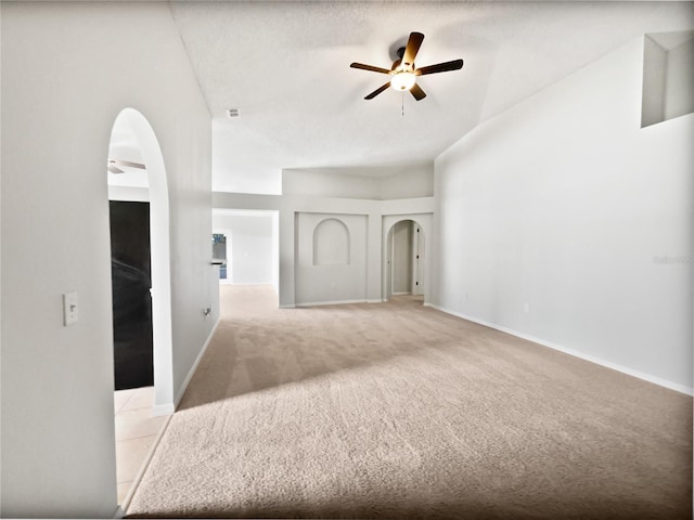 612 Doe Cove Pl, Apopka, FL 32703 - spare room featuring arched walkways, a ceiling fan, light colored carpet, baseboards, and vaulted ceiling
