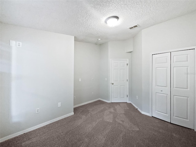 612 Doe Cove Pl, Apopka, FL 32703 - unfurnished bedroom with a textured ceiling, carpet floors, a closet, and baseboards