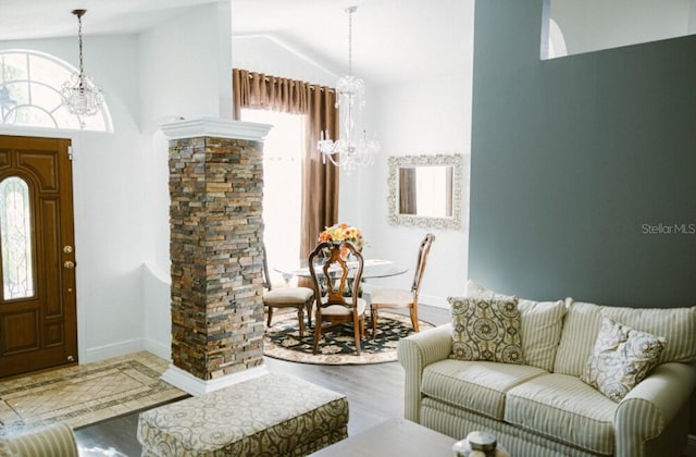 2102 Applegate Dr, Ocoee, FL 34761 - foyer entrance with a chandelier, wood finished floors, vaulted ceiling, and baseboards