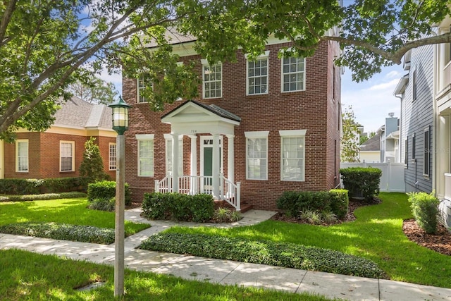 704 Honeysuckle Ave, Kissimmee, FL 34747 - georgian-style home with brick siding