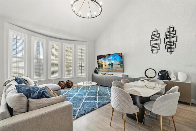 704 Honeysuckle Ave, Kissimmee, FL 34747 - living room with wood finished floors, a chandelier, and high vaulted ceiling