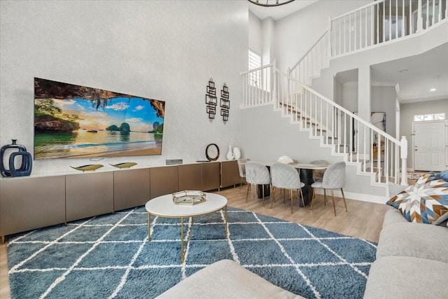704 Honeysuckle Ave, Kissimmee, FL 34747 - living room with a towering ceiling, wood finished floors, stairs, and baseboards
