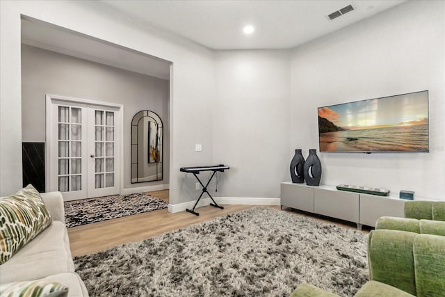 704 Honeysuckle Ave, Kissimmee, FL 34747 - living room with french doors, wood finished floors, recessed lighting, and baseboards