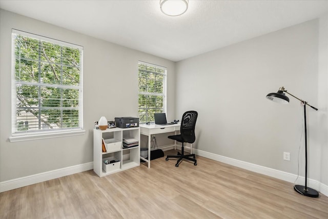 704 Honeysuckle Ave, Kissimmee, FL 34747 - office area featuring light wood-style floors and baseboards